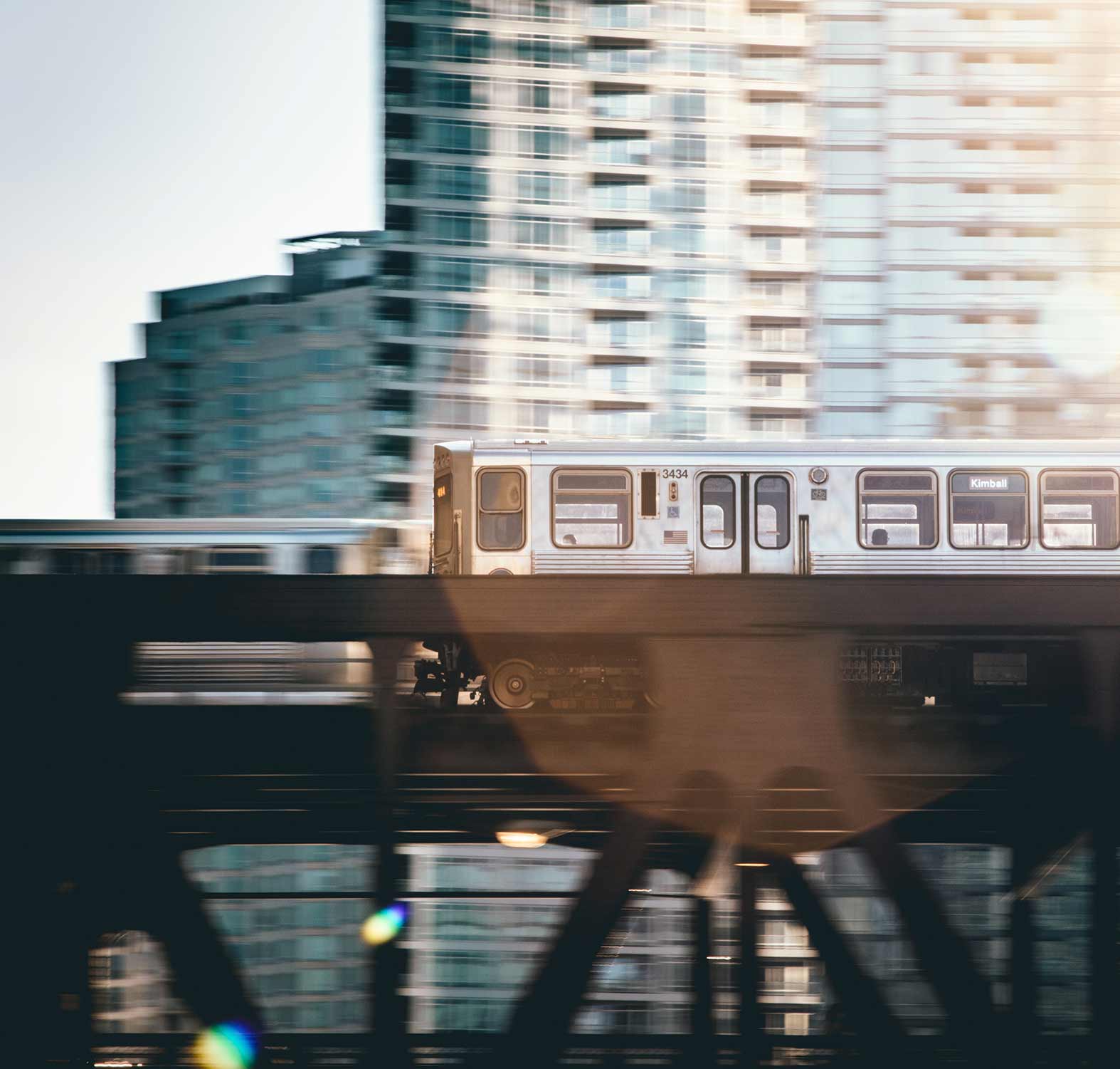 Passenger train going past skyscraper