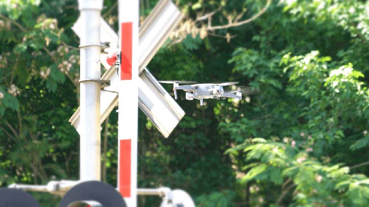 Drone examining railroad crossing